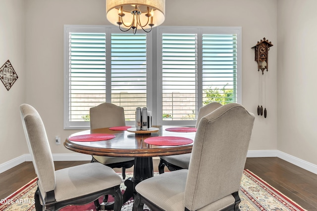 dining area with an inviting chandelier, baseboards, and wood finished floors