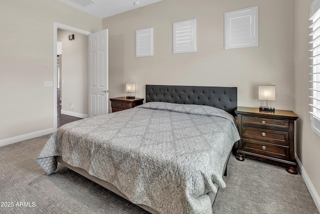 carpeted bedroom featuring visible vents and baseboards