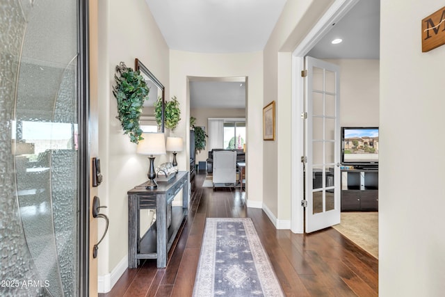 foyer featuring french doors, dark wood-type flooring, recessed lighting, and baseboards