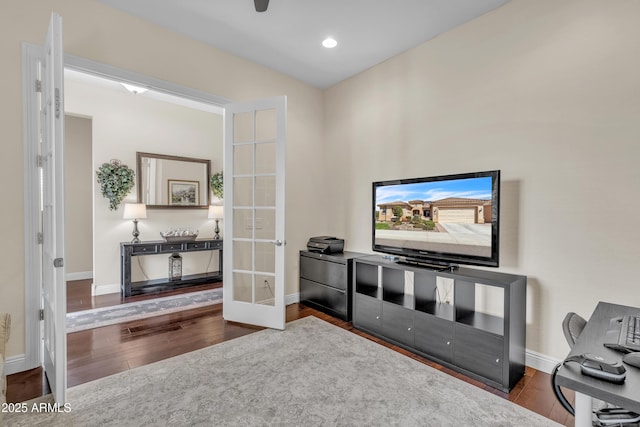 living area with recessed lighting, french doors, baseboards, and wood finished floors