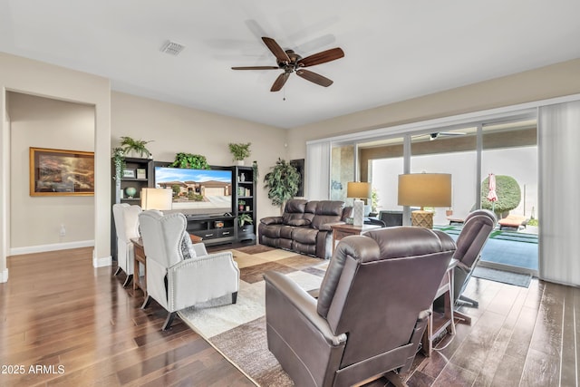 living area with baseboards, visible vents, ceiling fan, and wood finished floors