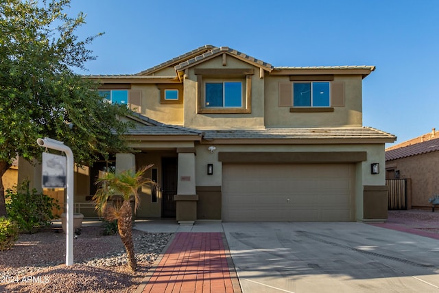 view of front of property featuring a garage, driveway, and stucco siding