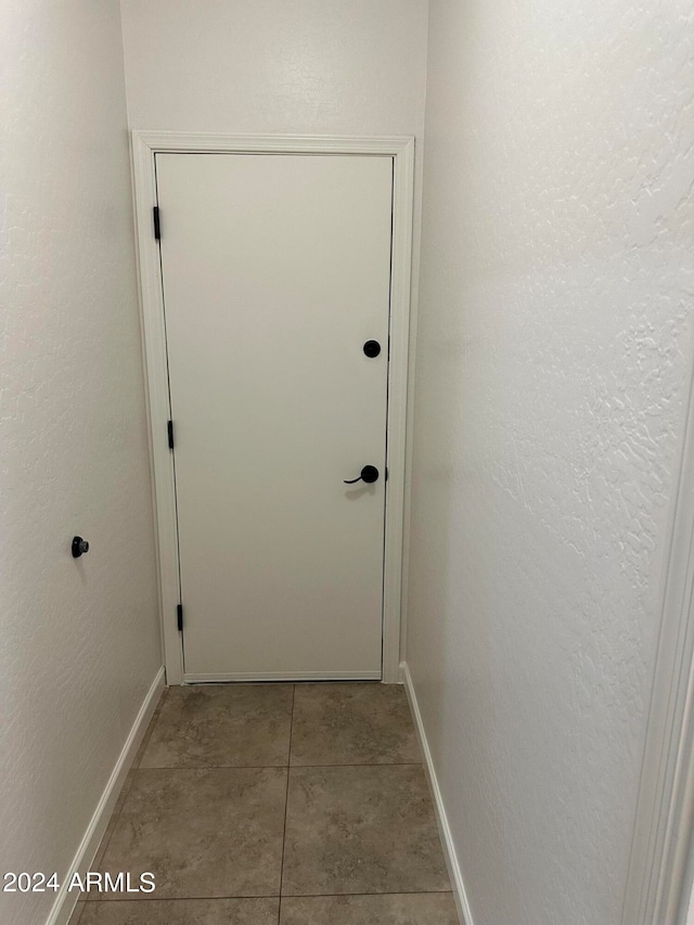 corridor featuring light tile patterned flooring