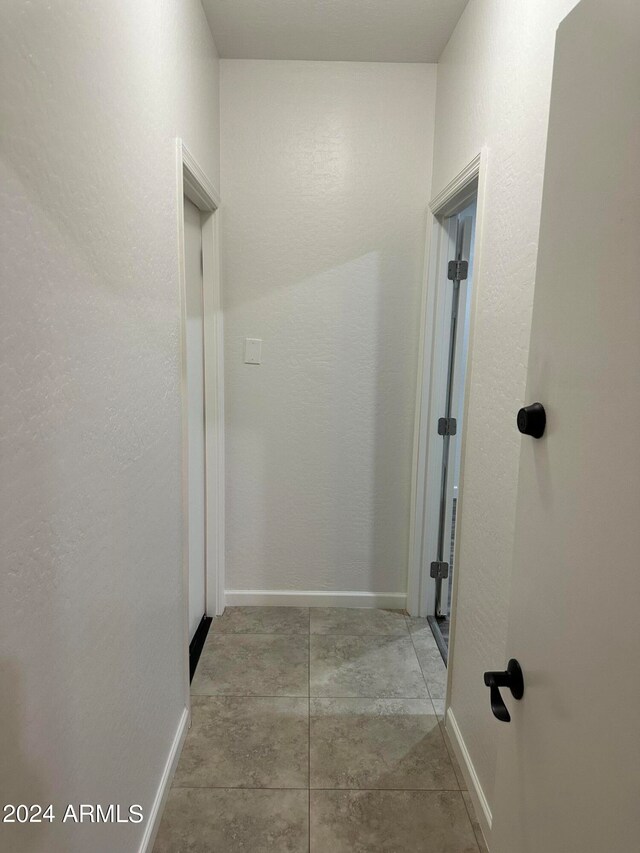 hallway with light tile patterned flooring