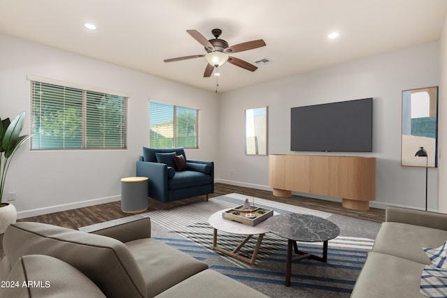 living room with visible vents, baseboards, and dark wood finished floors