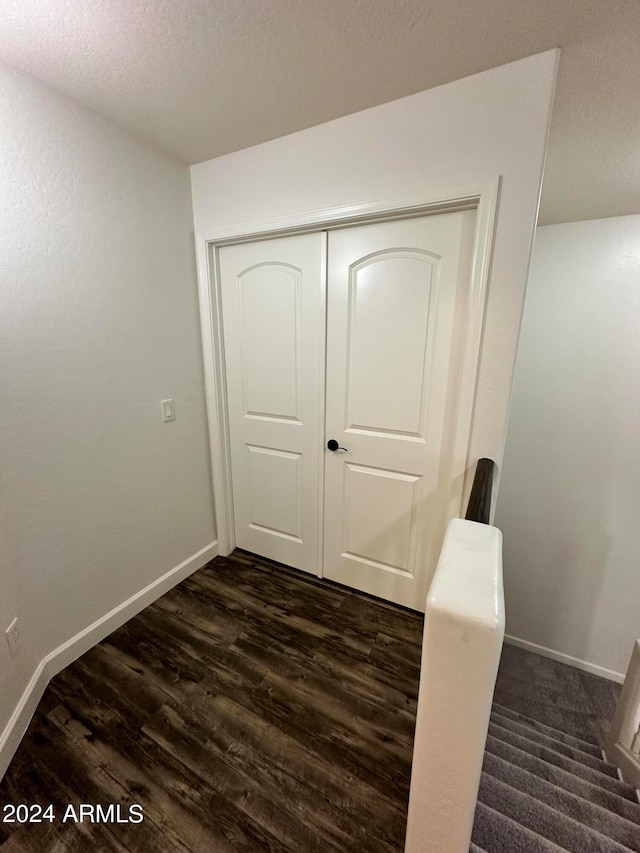 hallway featuring dark hardwood / wood-style flooring