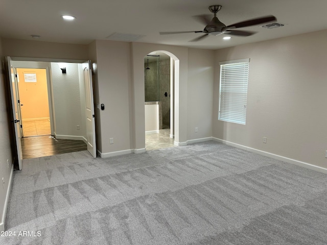 unfurnished room featuring ceiling fan and light colored carpet