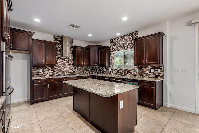 kitchen with light tile patterned flooring, visible vents, stainless steel appliances, and wall chimney range hood