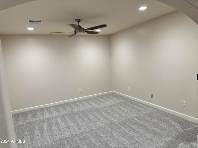 empty room featuring carpet floors and ceiling fan