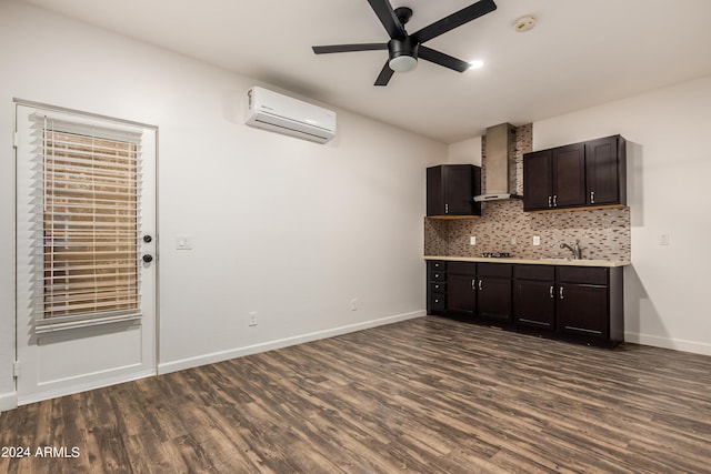 kitchen with a wall mounted air conditioner, backsplash, dark wood-style flooring, and wall chimney range hood