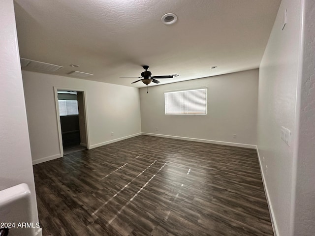 spare room with ceiling fan, dark hardwood / wood-style flooring, and a textured ceiling