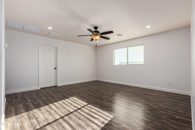 spare room with visible vents, baseboards, and wood finished floors