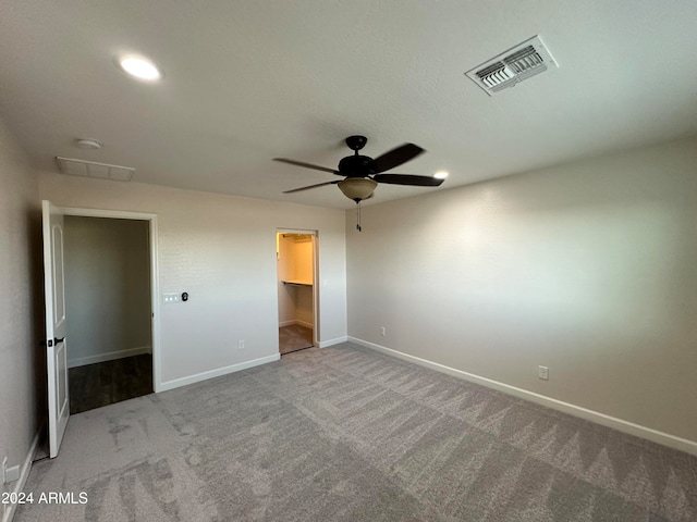 carpeted spare room with ceiling fan