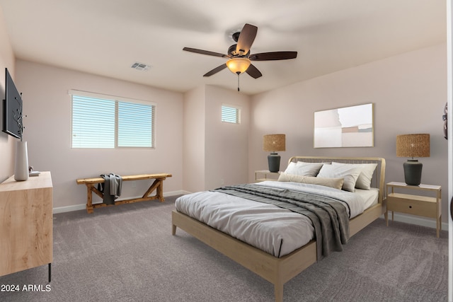 carpeted bedroom with visible vents, ceiling fan, and baseboards