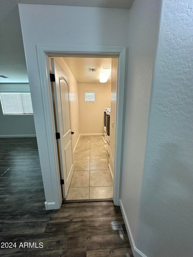 hallway with hardwood / wood-style floors and a healthy amount of sunlight