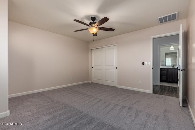 unfurnished bedroom with visible vents, a ceiling fan, a closet, carpet flooring, and baseboards