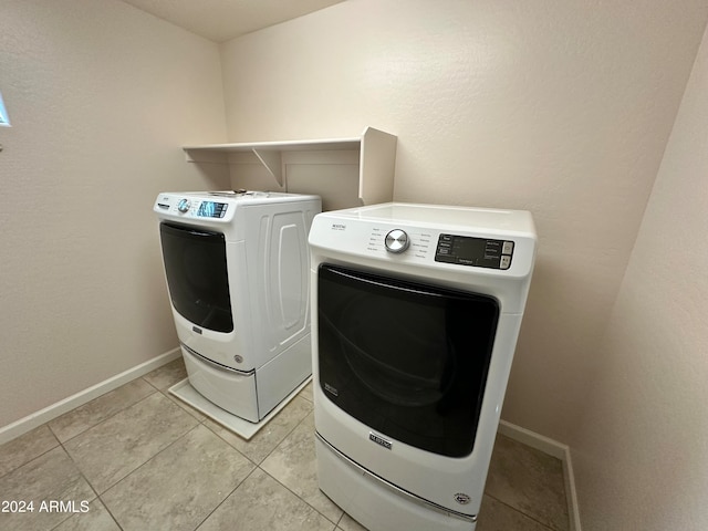 washroom with separate washer and dryer and light tile patterned floors