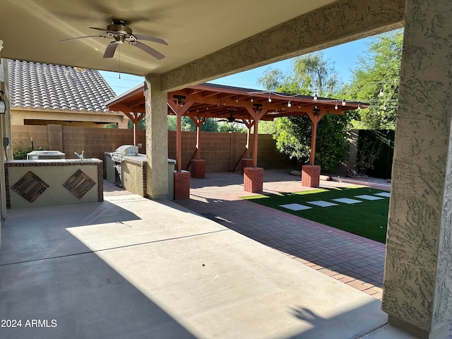 view of patio / terrace with ceiling fan and exterior kitchen