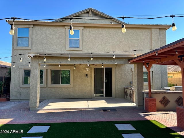 back of house with a patio