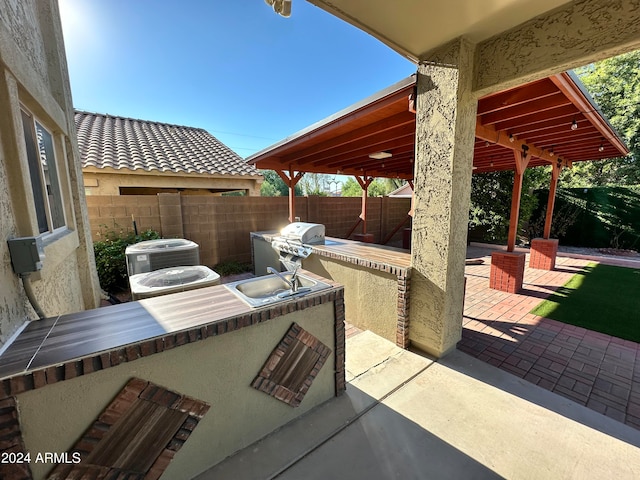 view of patio with area for grilling and cooling unit