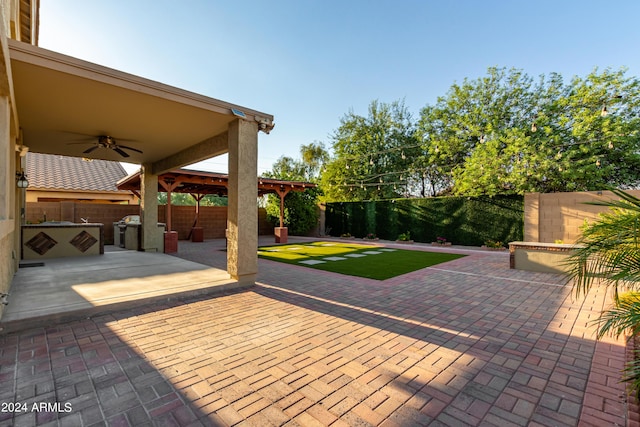 view of patio / terrace with a gazebo, a ceiling fan, and a fenced backyard