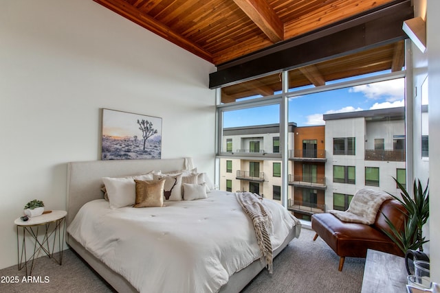 bedroom featuring wooden ceiling, carpet flooring, and beam ceiling