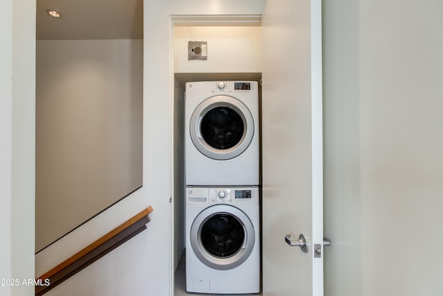 clothes washing area featuring stacked washer / dryer