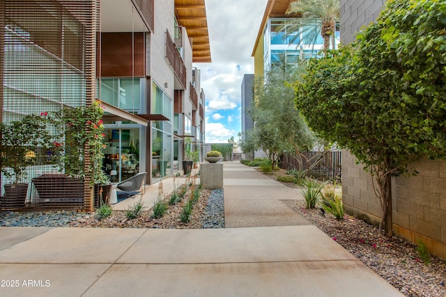 view of home's community with fence and a patio