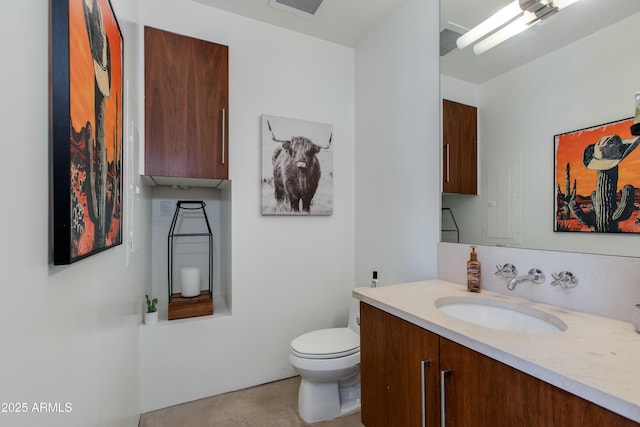 bathroom featuring toilet, vanity, and concrete floors