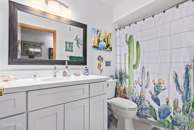 bathroom featuring tile patterned floors, vanity, and toilet