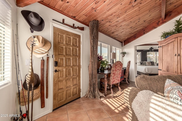 tiled foyer entrance featuring vaulted ceiling, ceiling fan, and wood ceiling