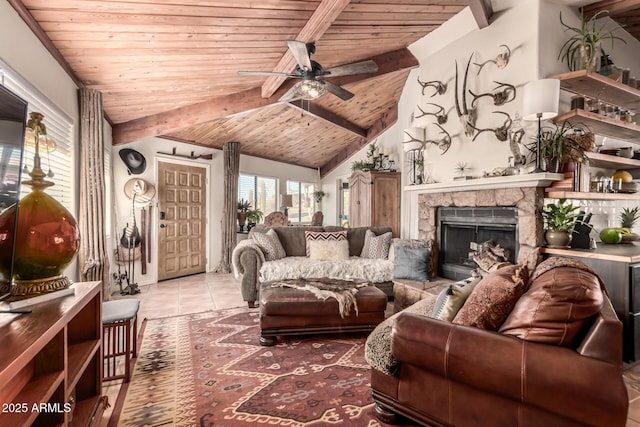 living area with light tile patterned floors, wood ceiling, a stone fireplace, ceiling fan, and lofted ceiling with beams