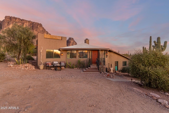 back house at dusk with a mountain view