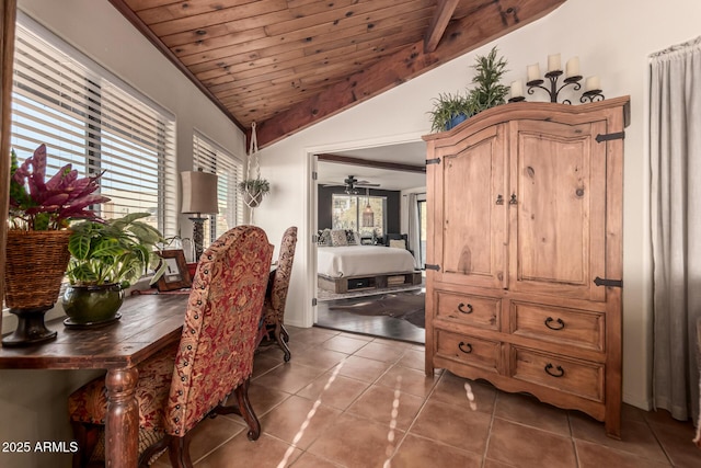 dining area with lofted ceiling, ceiling fan, wood ceiling, and dark tile patterned floors