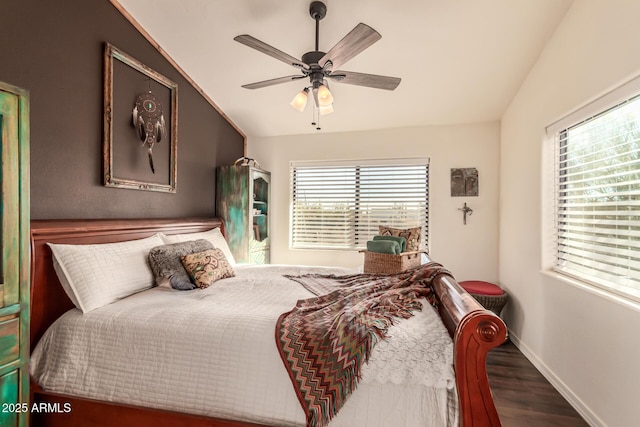 bedroom featuring ceiling fan, dark hardwood / wood-style flooring, lofted ceiling, and multiple windows