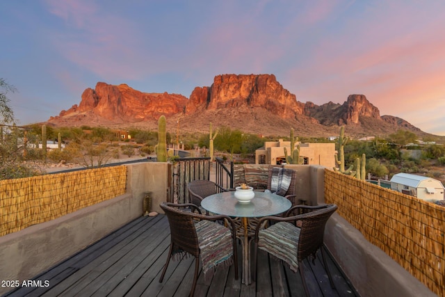 deck at dusk with a mountain view