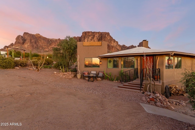 back house at dusk with a mountain view