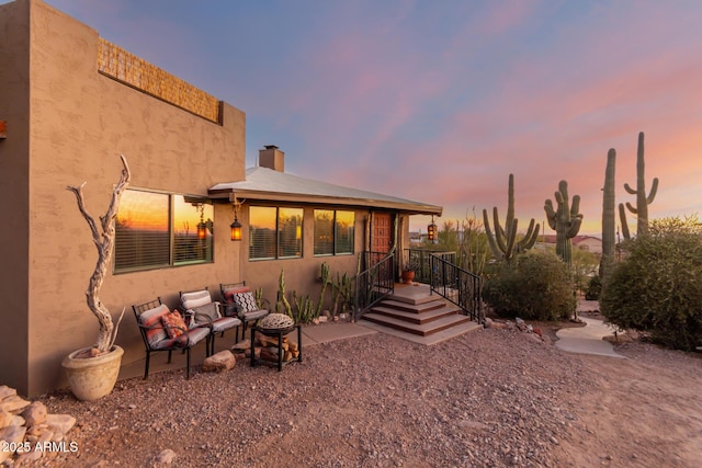 view of back house at dusk