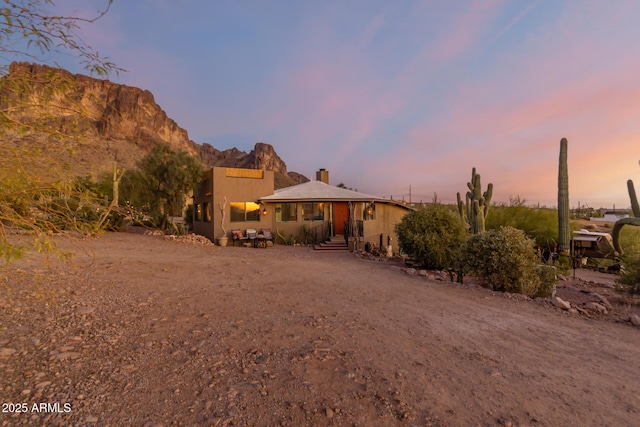 back house at dusk with a mountain view