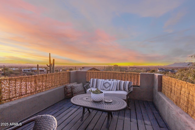 deck at dusk with an outdoor hangout area