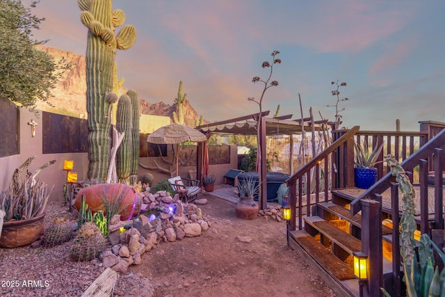 yard at dusk with a hot tub