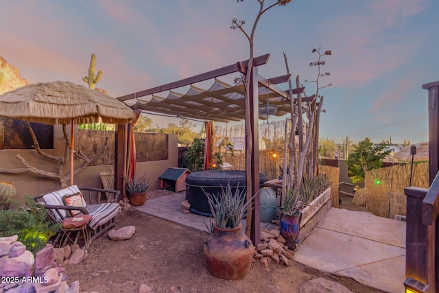 patio terrace at dusk featuring a pergola