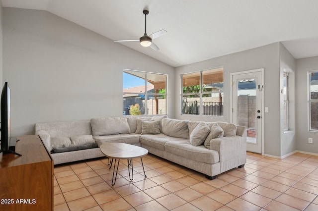 living room featuring a ceiling fan, lofted ceiling, and light tile patterned flooring