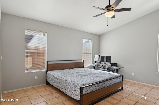 tiled bedroom with baseboards, ceiling fan, and lofted ceiling