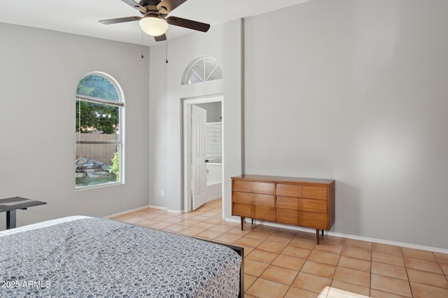bedroom featuring baseboards and light tile patterned floors