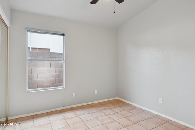 unfurnished room with ceiling fan and baseboards