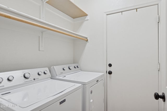 clothes washing area featuring laundry area and washer and clothes dryer
