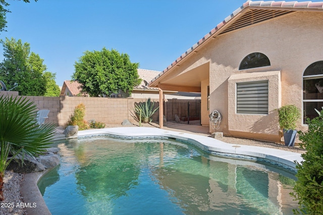 view of swimming pool featuring fence and a fenced in pool