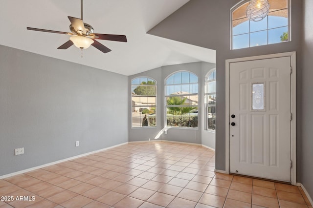 foyer entrance with light tile patterned floors, baseboards, ceiling fan, and lofted ceiling