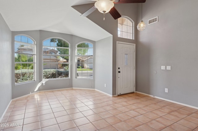 entrance foyer featuring ceiling fan, baseboards, light tile patterned floors, vaulted ceiling, and visible vents
